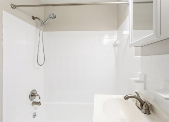 a white bathroom with a shower and a sink at Stonebridge, Ellington, CT, 06029