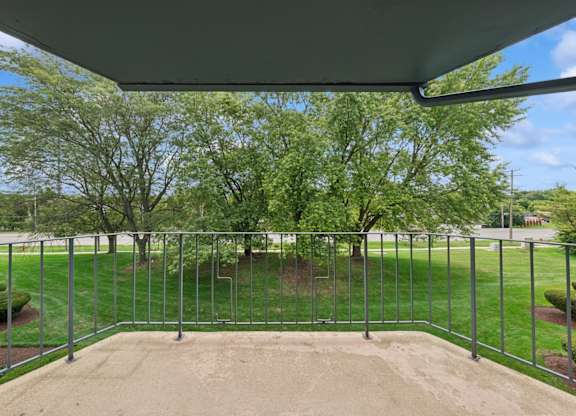 A metal fence encloses a sandy area.