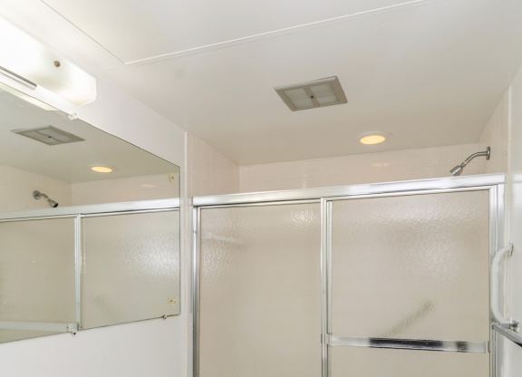A white toilet and sink in a small bathroom.