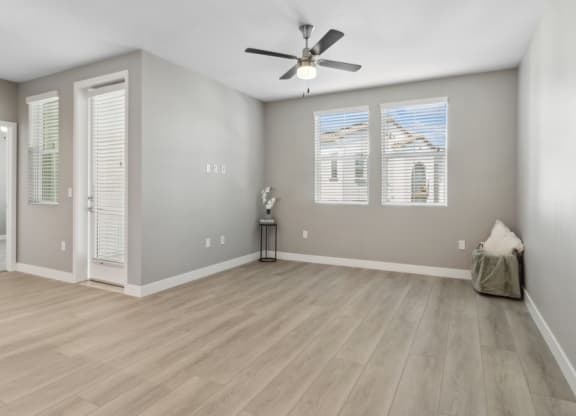 Empty living room with a ceiling fan and windows at Arrive Temecula