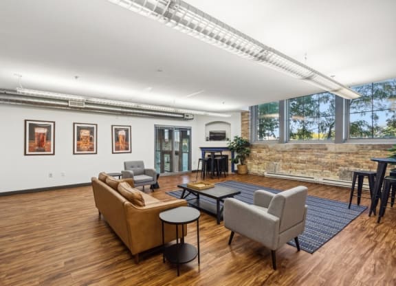 Room with sofa, wood floors, and chairs