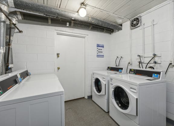 a laundry room with two washes and two dryers at Briarwood Apartments, Dumfries, VA, 22026