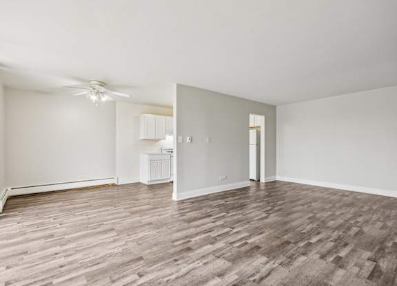 A room with wooden flooring and a ceiling fan.