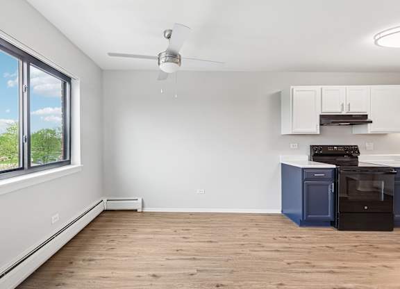 A kitchen with a blue oven and white cabinets.