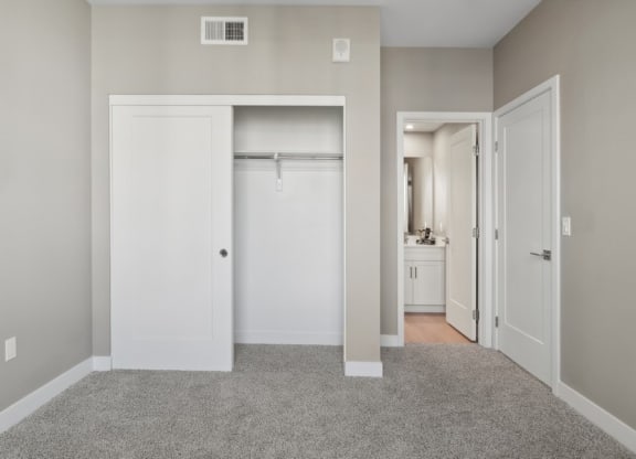 an empty bedroom with a closet and view to a bathroom at Arrive Temecula