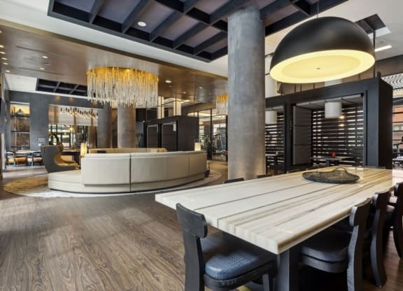 a dining room with a table and chairs in front of a wine cellar
