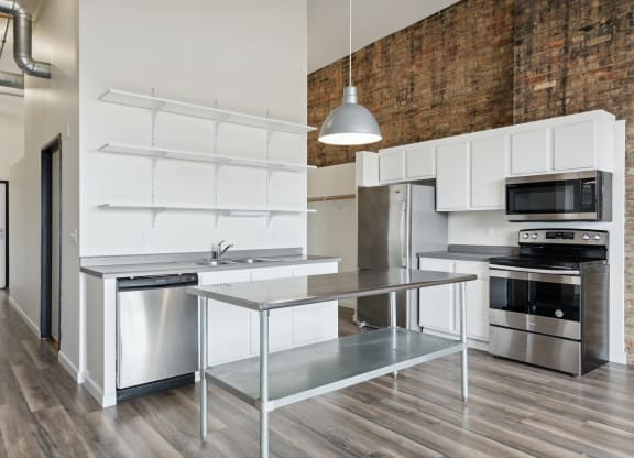 a kitchen with white cabinetry and stainless steel appliancesat Gaar Scott Historic Lofts, Minnesota, 55401