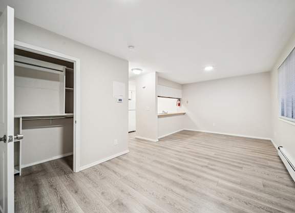 A room with a white ceiling and a wooden floor.