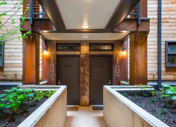 Covered entrance with dual doors and planters at Brooklyn Yard Apartments, Portland
