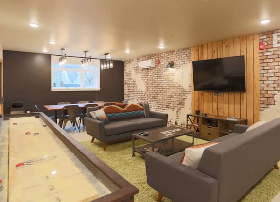 Basement recreation room with shuffleboard and tv at Brooklyn Yard Apartments, Oregon, 97202