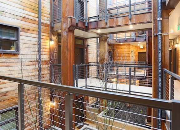 Interior courtyard with wood siding and metal railings at Brooklyn Yard Apartments, Oregon, 97202