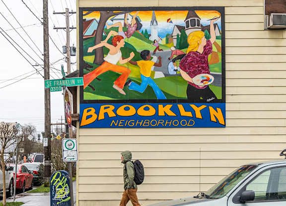 Neighborhood welcome mural on building exterior at Brooklyn Yard Apartments, Portland