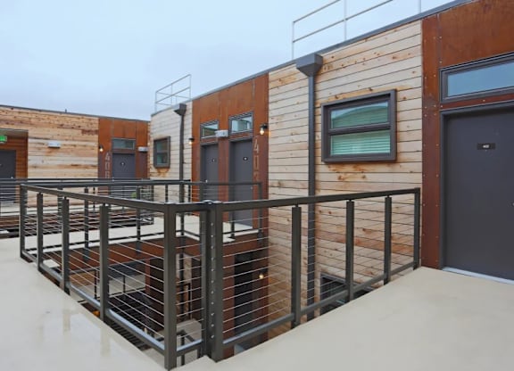 Rooftop deck with black metal railings and wood siding at Brooklyn Yard Apartments, Portland, Oregon