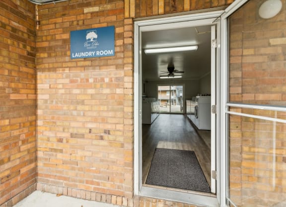 the door to the laundry room is open in a brick building at River Oaks, North Aurora, Illinois