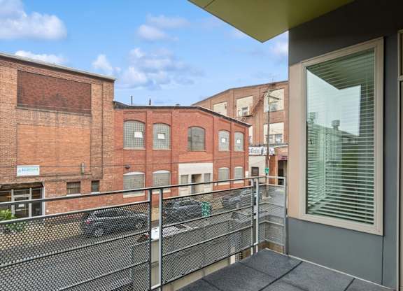 A balcony with a metal railing and a glass door.