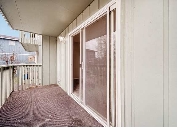 A patio with a sliding glass door.