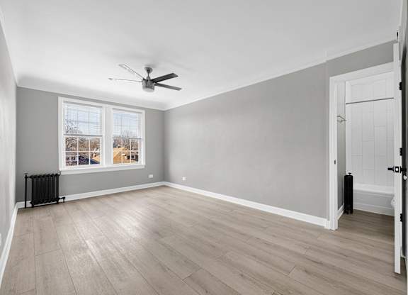 A room with a ceiling fan and a window with a view at Pleasant Oak Apartments, Oak Park, 60302