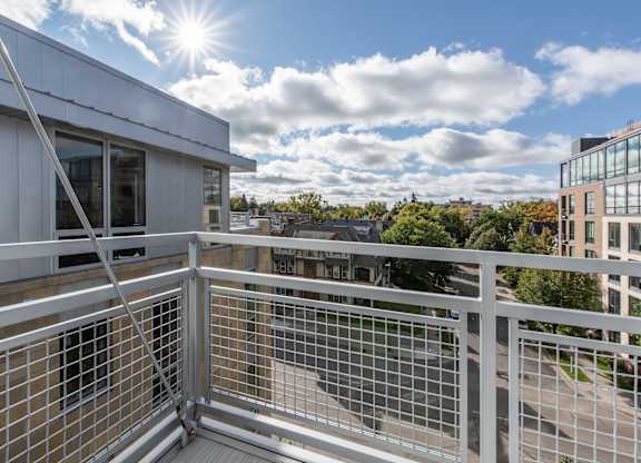 Private balcony with metal railing and city views at 1800 Lake Apartments, Minneapolis, Minnesota