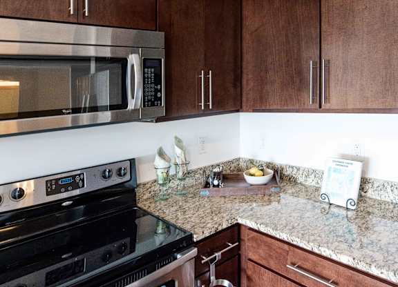 Corner kitchen with stainless appliances and granite counters at 1800 Lake Apartments, Minnesota