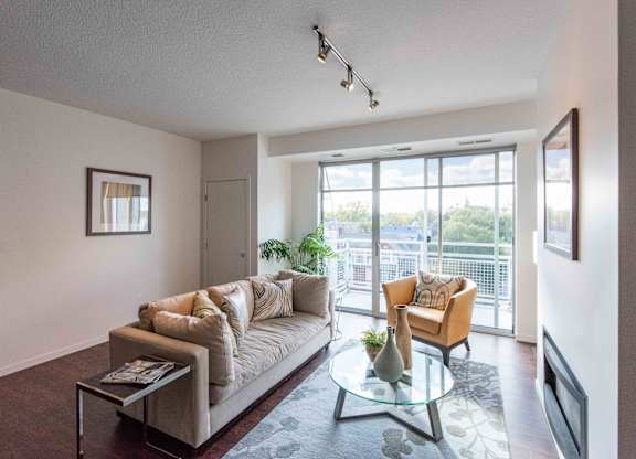 Living room with sliding door and balcony access at 1800 Lake Apartments, Minneapolis, MN