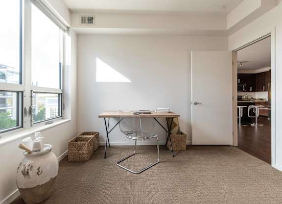 Minimalist home office with natural light and simple desk at 1800 Lake Apartments, Minnesota