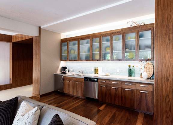 Wet bar with glass front cabinets and dishwasher at 1800 Lake Apartments, Minneapolis, 55408