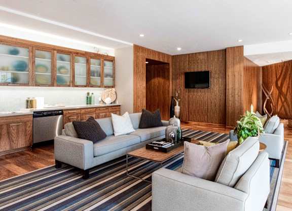 Open lounge area with wood paneling and sofas at 1800 Lake Apartments, Minneapolis, Minnesota