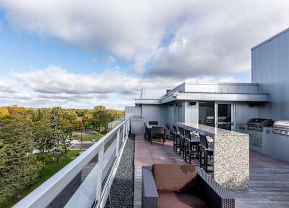 Rooftop deck with outdoor kitchen and park overlook at 1800 Lake Apartments, Minneapolis, MN