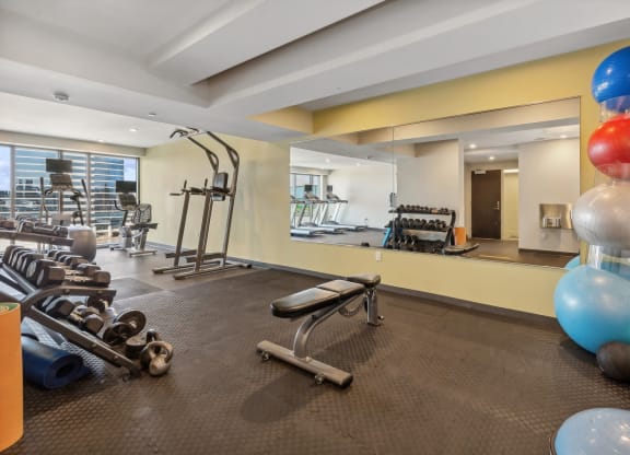 a gym with weights and balloons on the floor and a large mirror at The Rowe, Grand Rapids, Michigan