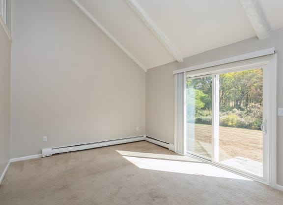 Empty carpeted room with sliding doors
