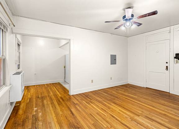A room with a ceiling fall and wooden floors