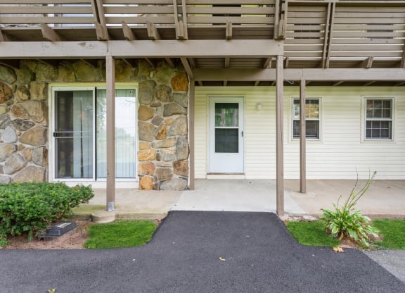 the front porch of an apartment entrance with a white door at Stonebridge, Connecticut, 06029