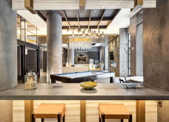 a kitchen and living room with a pool table and a chandelier
