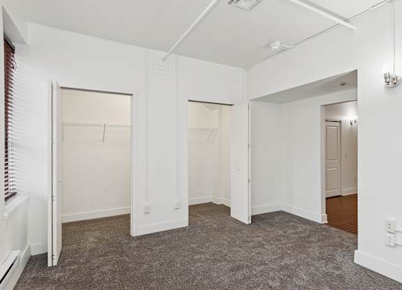 A room with white walls and carpeted floor.