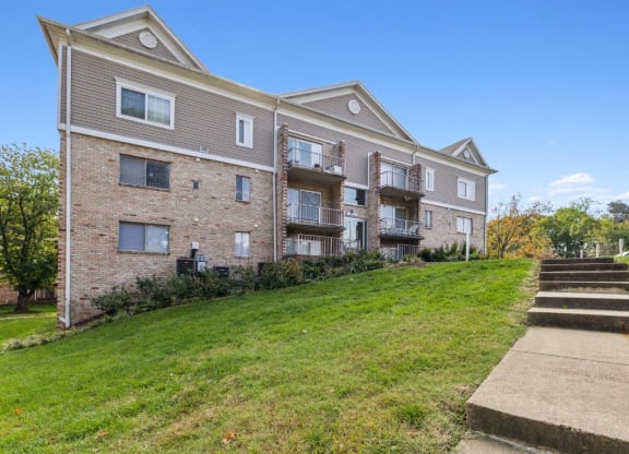 the outlook of an apartment building with stairs leading up to it at Briarwood Apartments, Dumfries, 22026