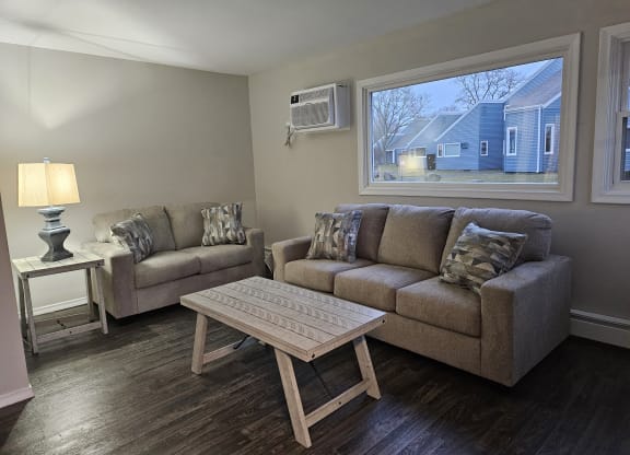 a living room with a couch and a table at The Flats at Talcott, Weatogue, Connecticut, 06089
