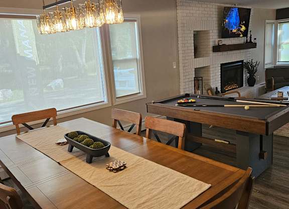 Clubhouse table with billiards table behind