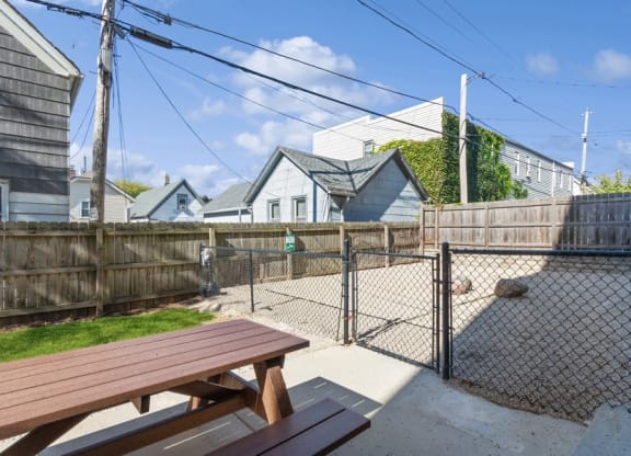 a picnic table in a fenced in area with a chain link fence