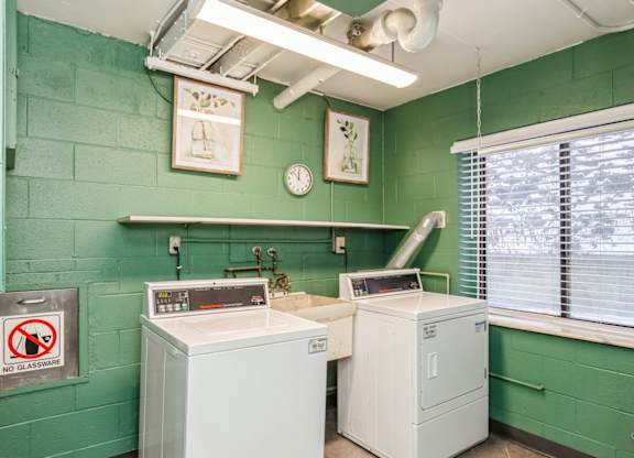 A laundry room with a washer and a dryer.