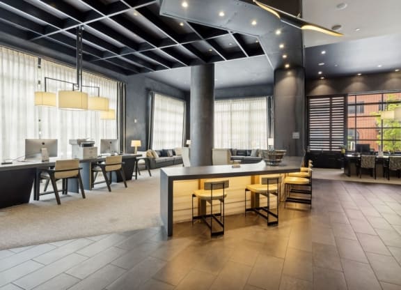 the lobby of a hotel with tables and chairs and a bar