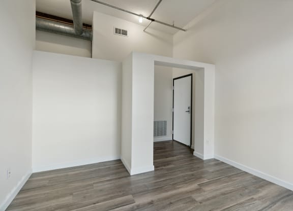 a bedroom with hardwood floors and white wallsat Gaar Scott Historic Lofts, Minnesota, 55401