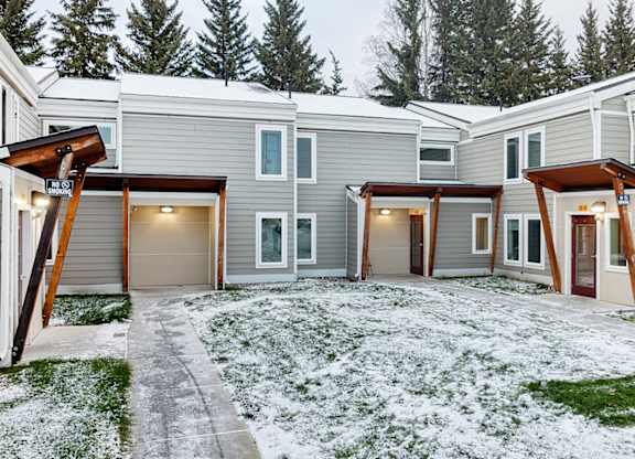 A row of houses with snow on the ground.