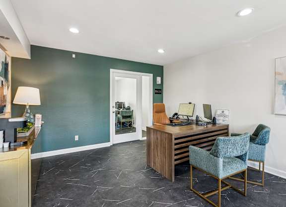 A reception area with a desk and chairs.