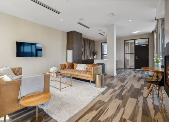 a living room with a couch and a tv at The Rowe, Grand Rapids
