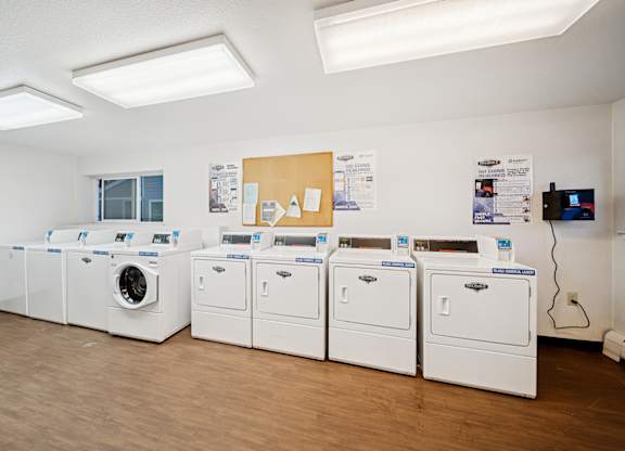 A row of washing machines in a laundromat.