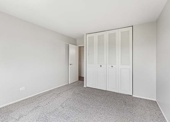 bedroom with carpet and closet doors