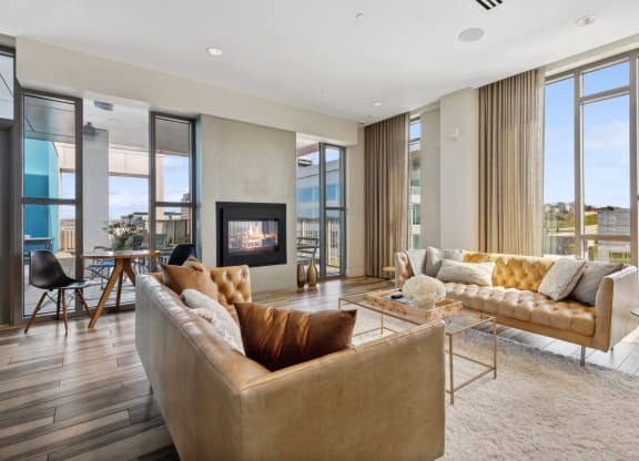 a living room with couches and a fireplace at The Rowe, Grand Rapids, 49503