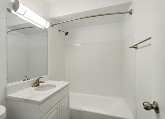 a bathroom with a sink and a bathtub at The Hinsdale, Illinois, 60521