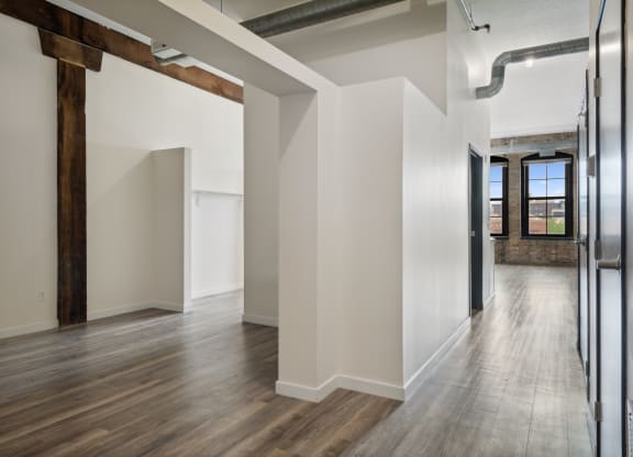 a large empty room with white walls and a wooden floor at Gaar Scott Historic Lofts, Minneapolis, Minnesota