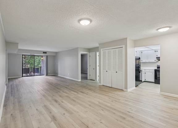 A room with wooden flooring and white walls.